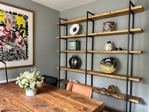 styled dark wood bookcase with vases and decor