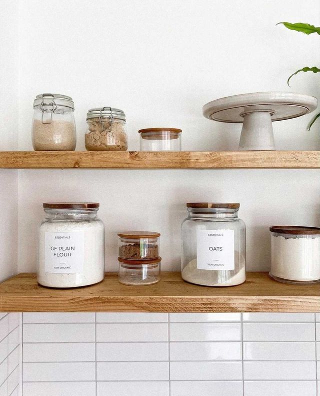 Wooden Kitchen Floating Shelves with labelled pantry storage glass jars, cake stand, kilner jars and a white wall