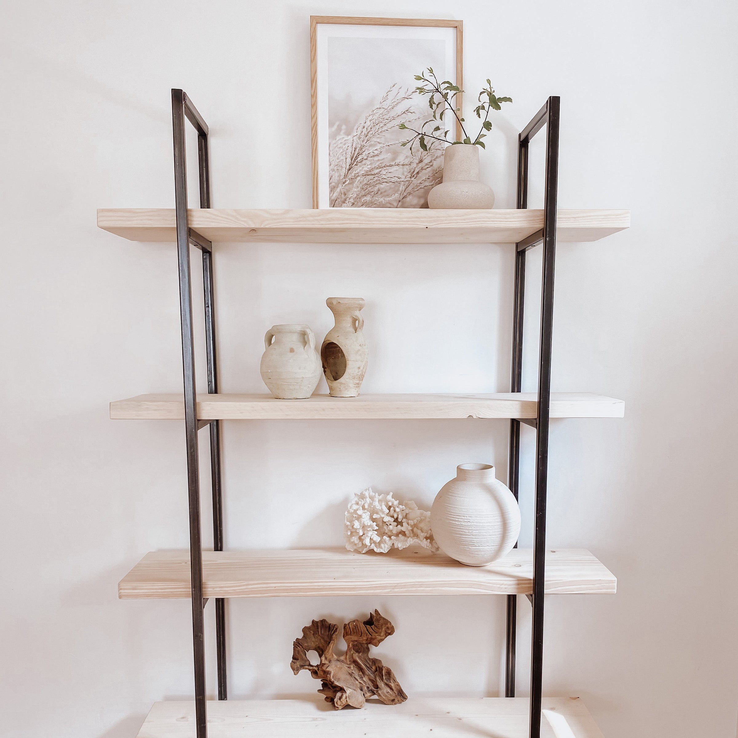 Rustic Wooden Bookcase Reclaimed Wood White Minimalist decor with white vases and pottery.