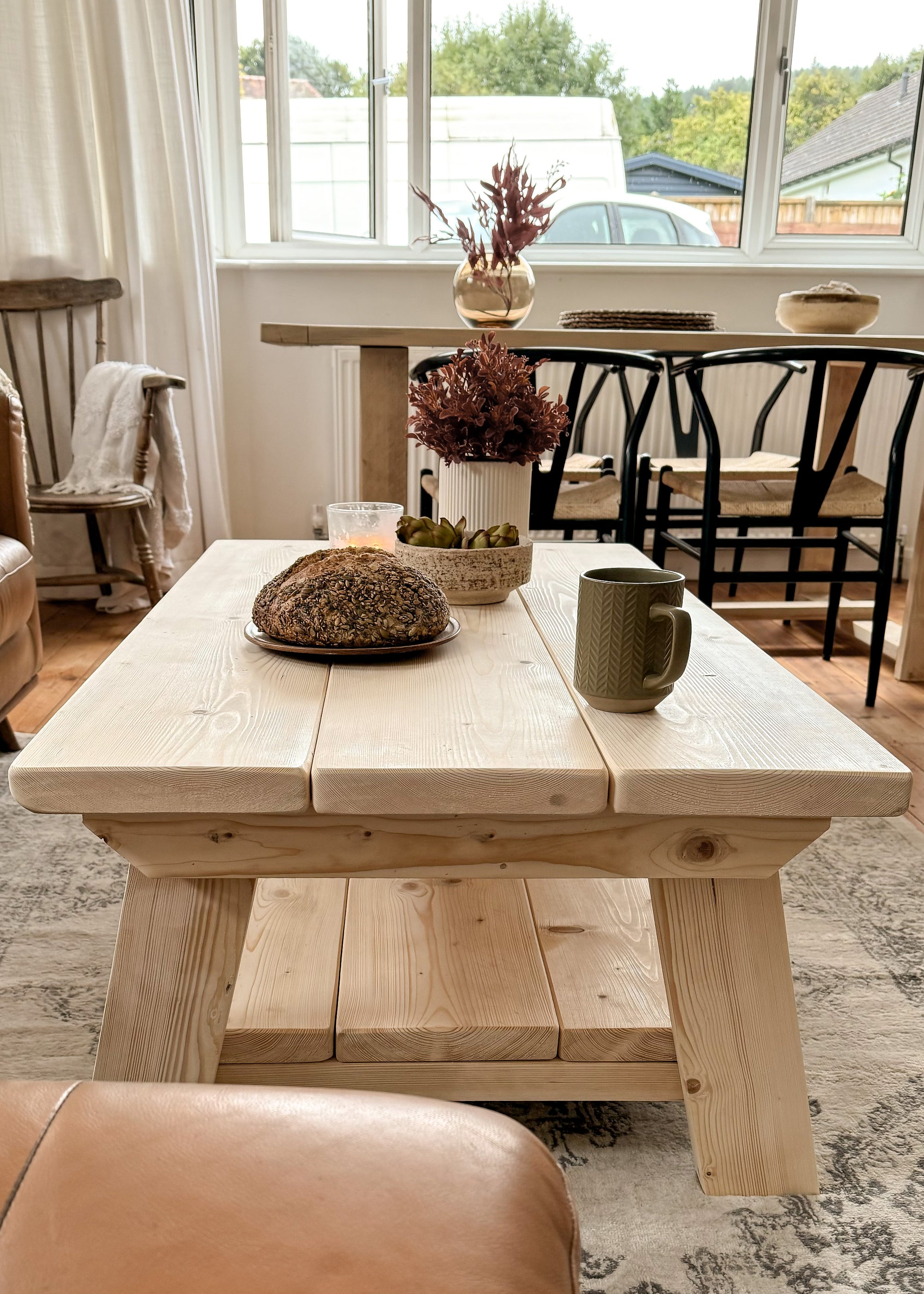 Side view of The Cotswold Coffee Table showing angled legs and the rustic reclaimed wood finish.