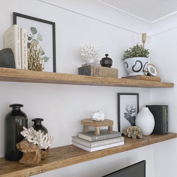 Floating shelves in a living room made from solid rustic wood