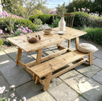Wooden outdoor table and bench set with decorative items on a patio