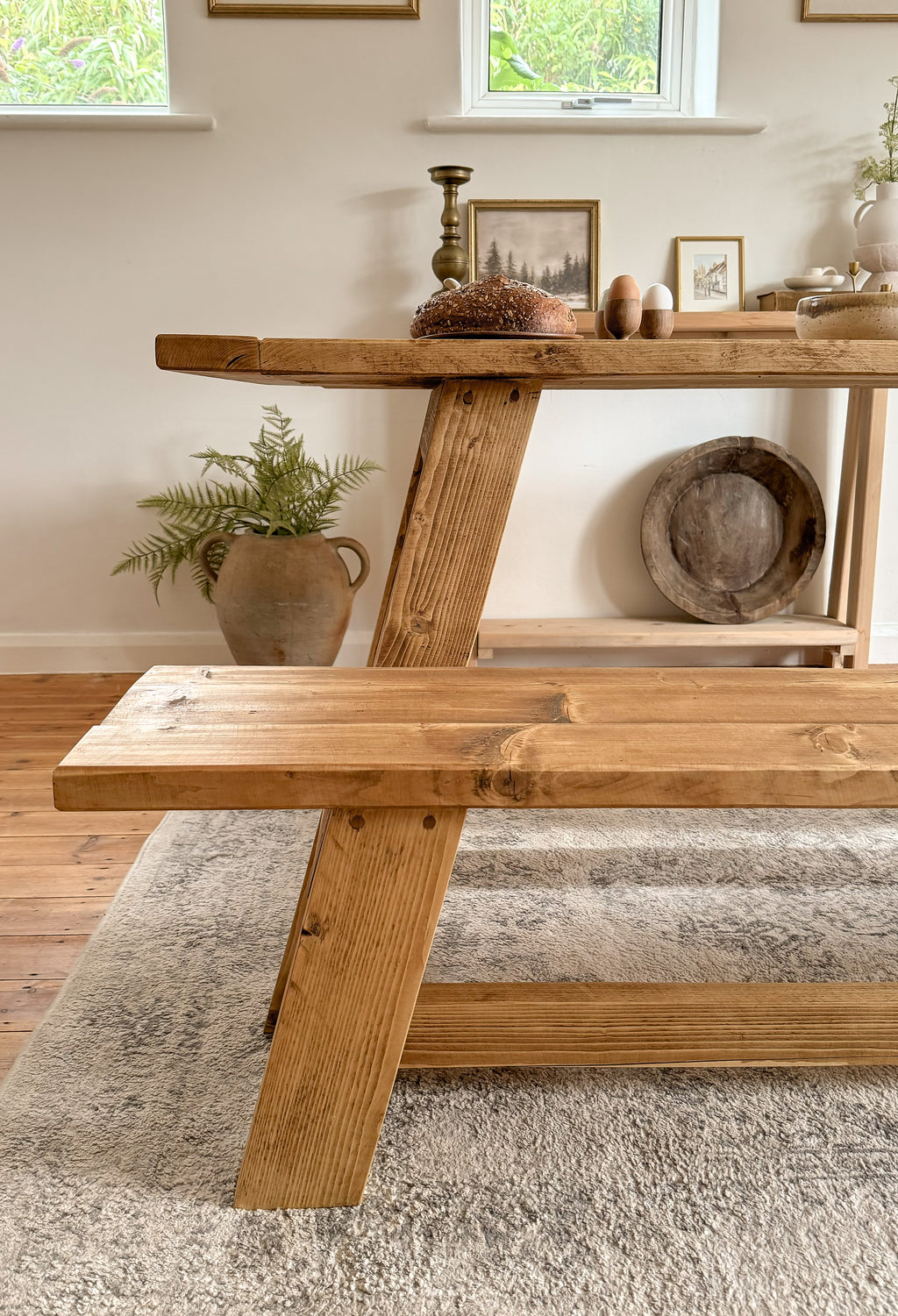 The end of the rustic dining table showing the legs and dowel joinery.
