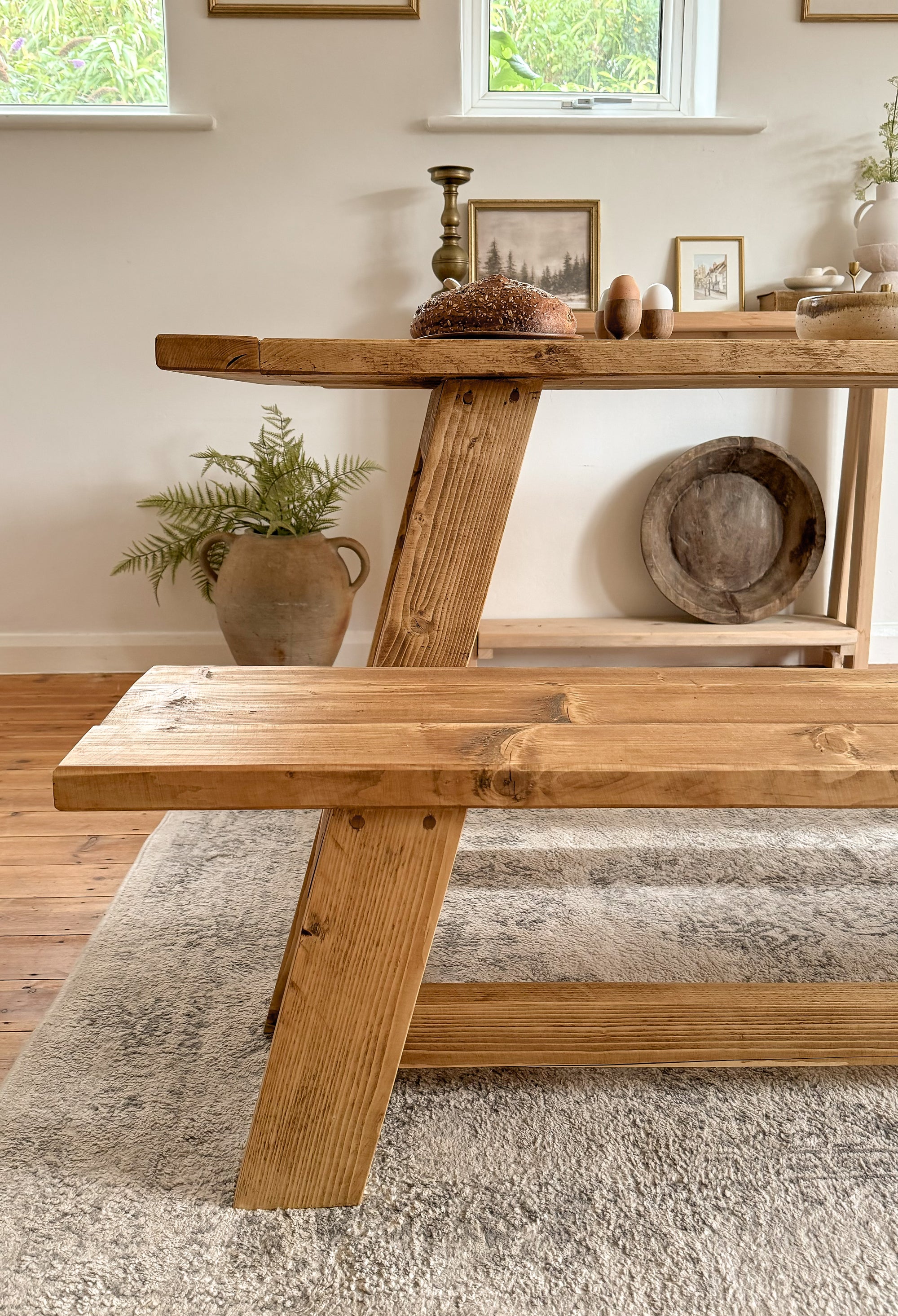 The end of the rustic dining table showing the legs and dowel joinery.