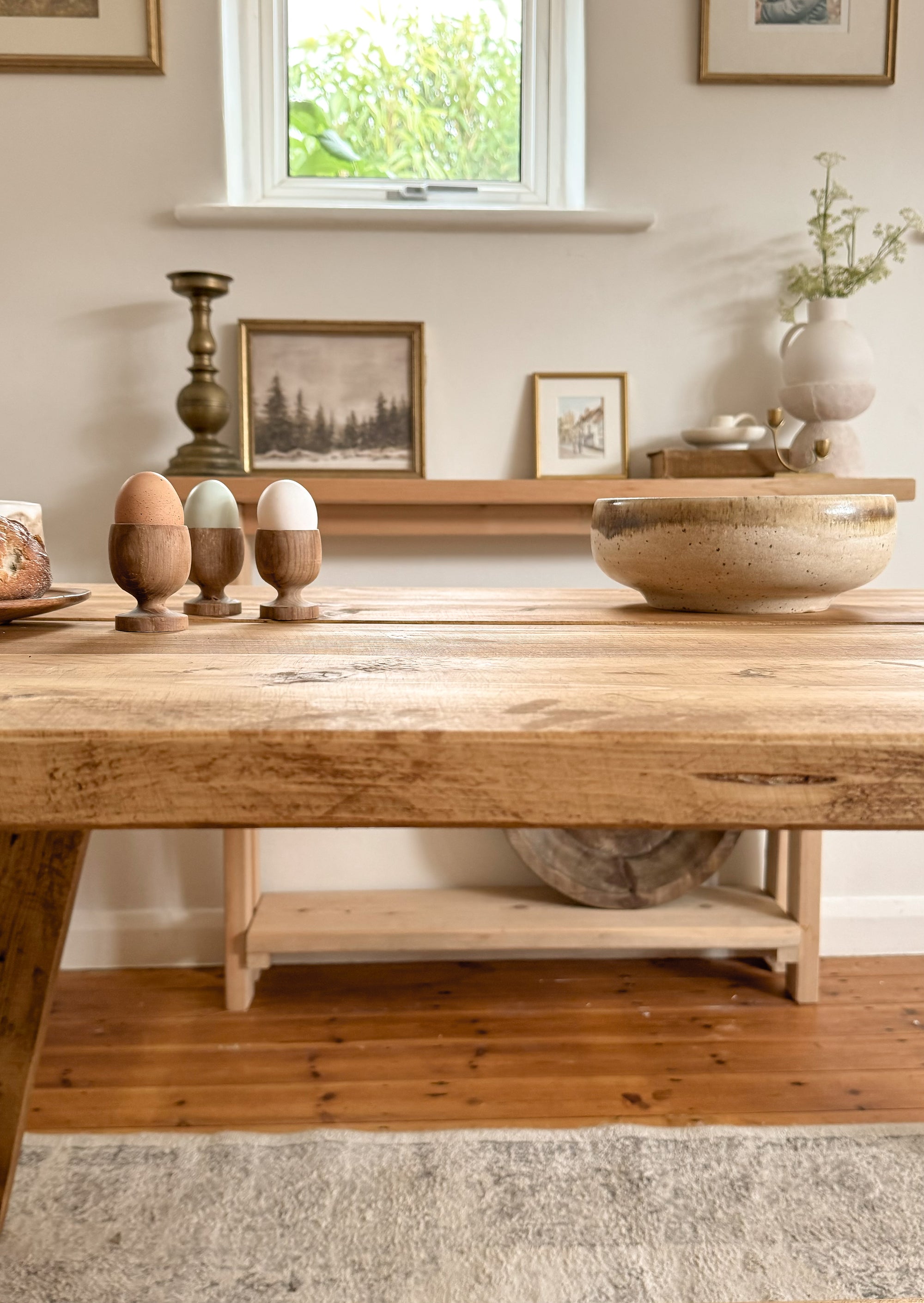 Close up of the edge of the reclaimed wooden top of the rustic dining table, showing the character of the solid wood.